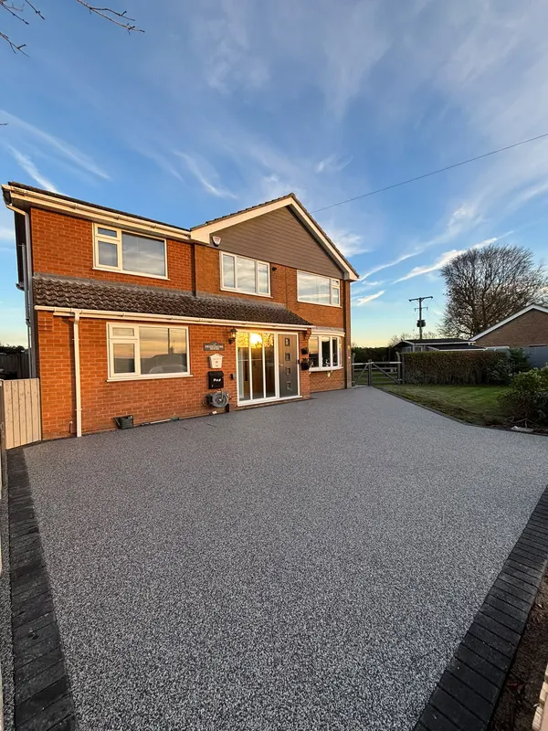 Warm tan resin drive on a detached home