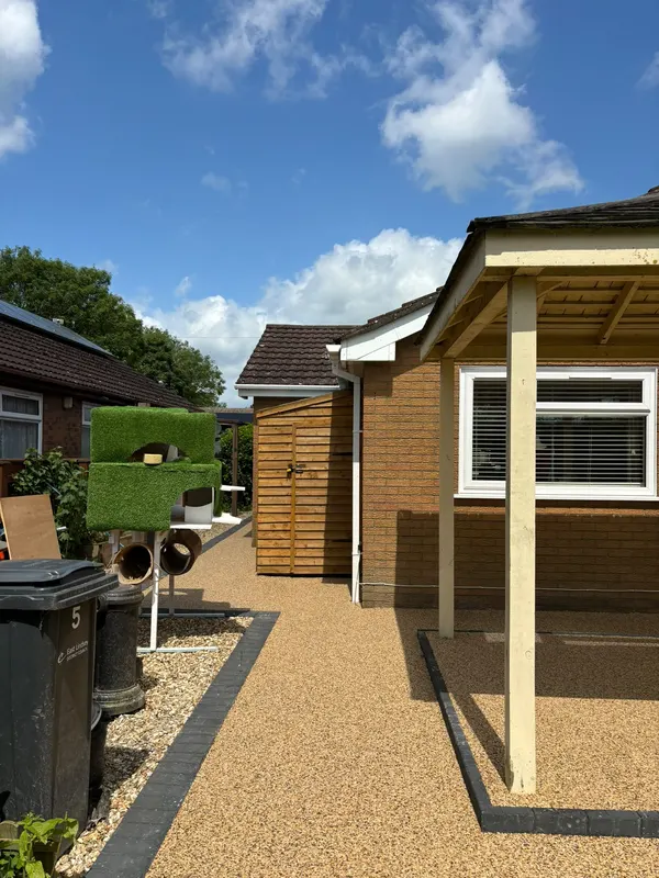 Resin drive beside a timber garage